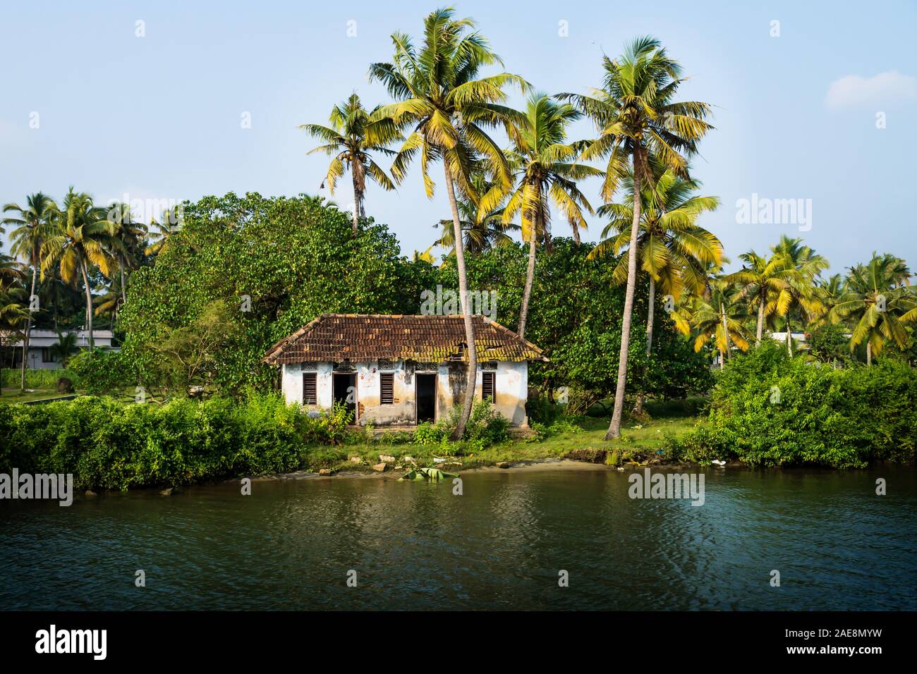 Abandoned house front view in the Kerala backwater with palm trees at Kollam Kottapuram Waterway, Kerala, India Stock Photo