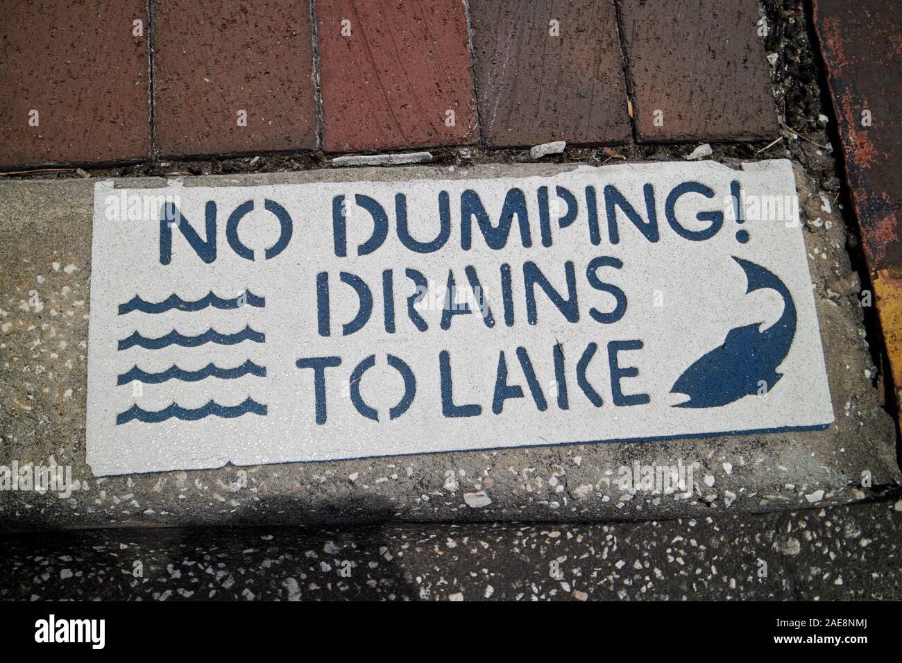 rainwater drain with no dumping drains to lake sign on sidewalk kissimmee florida usa Stock Photo