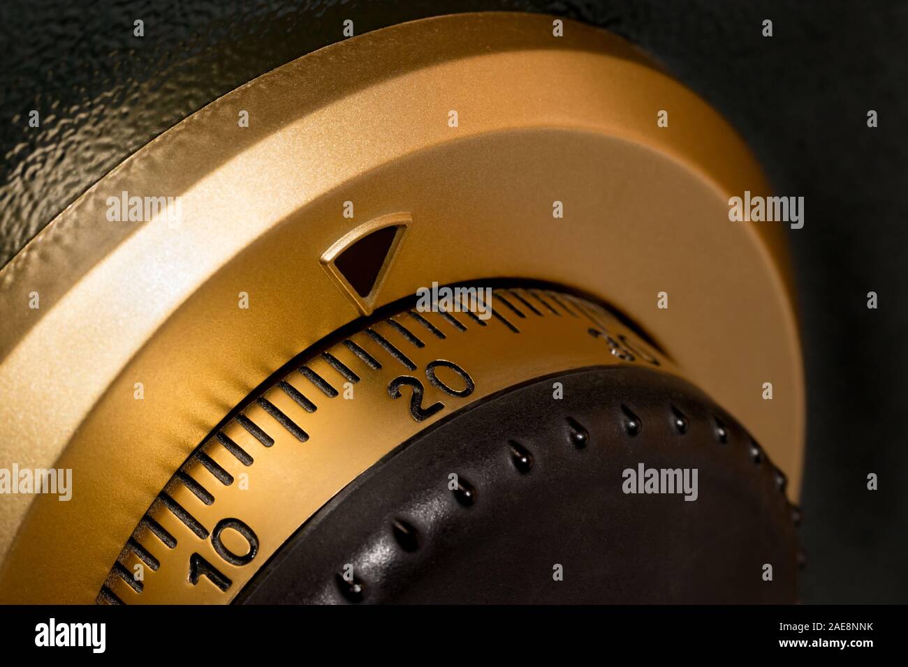 Isolated closeup of safe or vault combination lock with gold dial and black numbers. Concept of strong security and safety Stock Photo