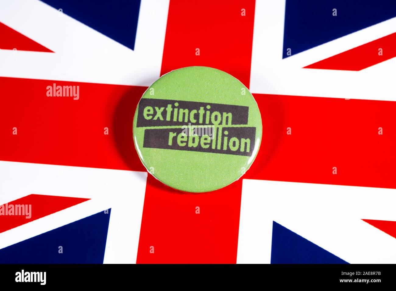 London, UK - November 22nd 2019: The symbol of Extinction Rebellion - the global environmental movement, pictured over the flag of the United Kingdom. Stock Photo