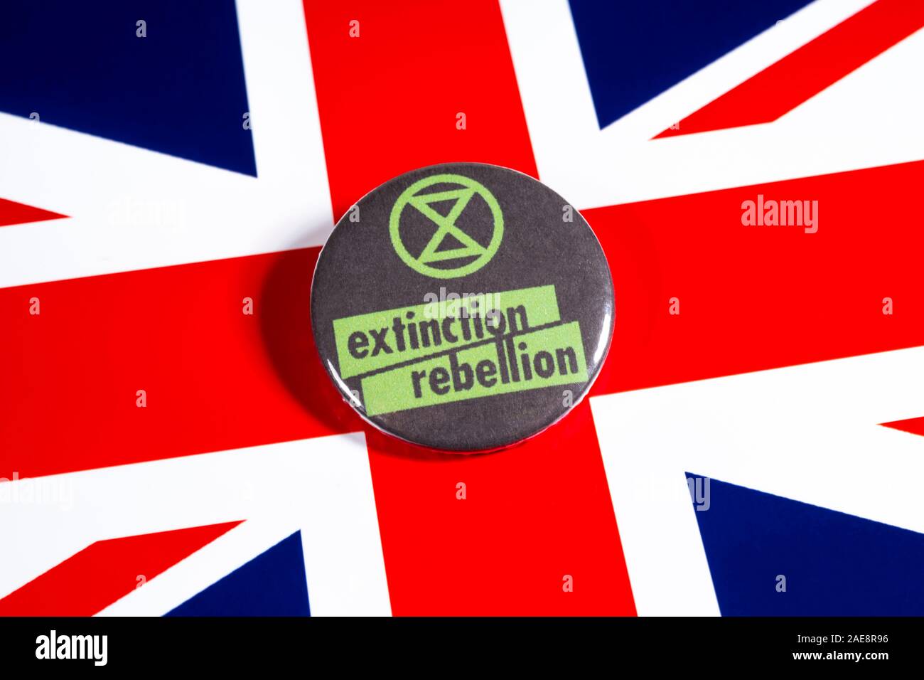 London, UK - November 22nd 2019: The symbol of Extinction Rebellion - the global environmental movement, pictured over the flag of the United Kingdom. Stock Photo