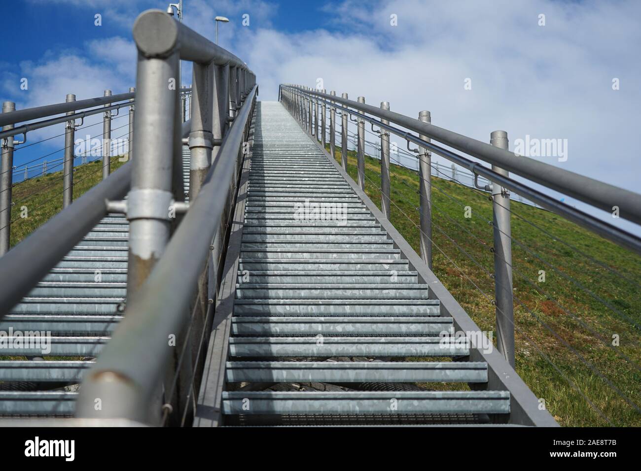 Wide angle shot of metal stairs leading up into the sky Stock Photo