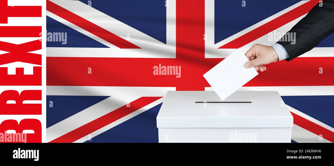 Election in England. The hand of man putting his vote in the ballot box. Waved Brexit flag on background. Stock Photo