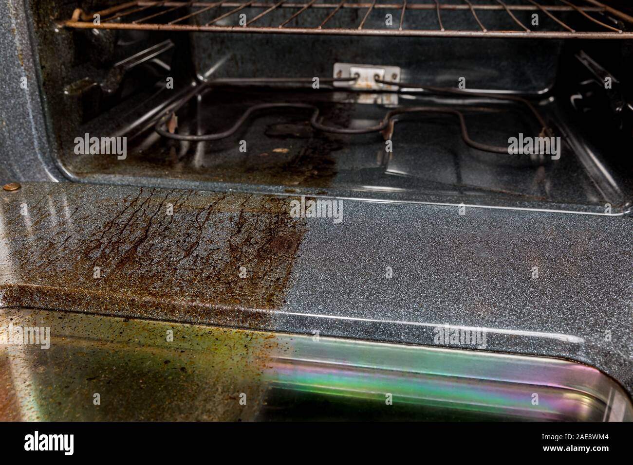 view inside electric oven with one half shiny clean and other side