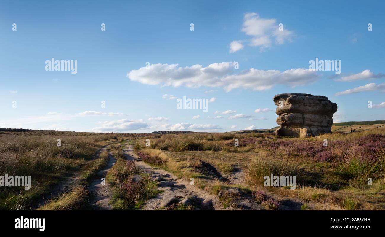Eagle Stone on Froggatt Edge in the Derbyshire Peak district, UK. Summer moorland with heather Stock Photo