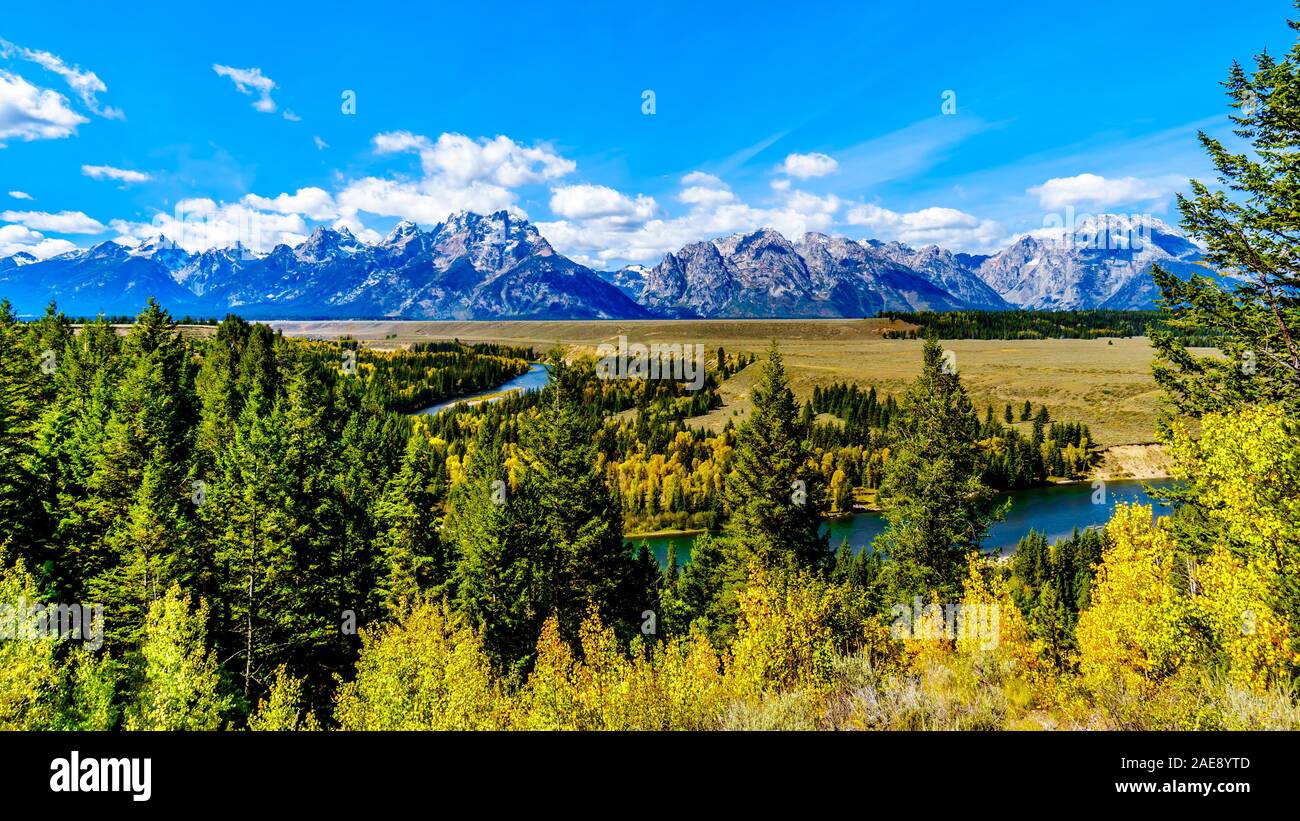 The peaks of The Grand Tetons behind the winding Snake River viewed