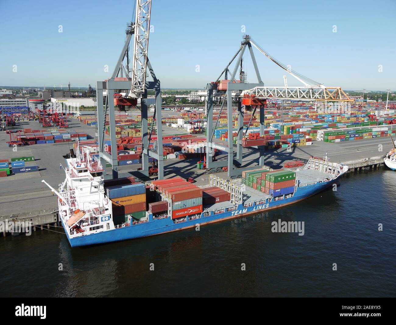 A container ship is being loaded in the port of Hamburg, Germany Stock Photo