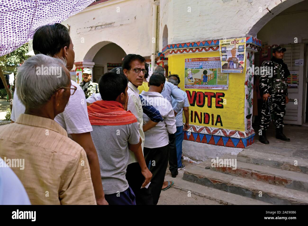 People queue outside a polling station in Patna, India during the general elections held in May 2019. Stock Photo