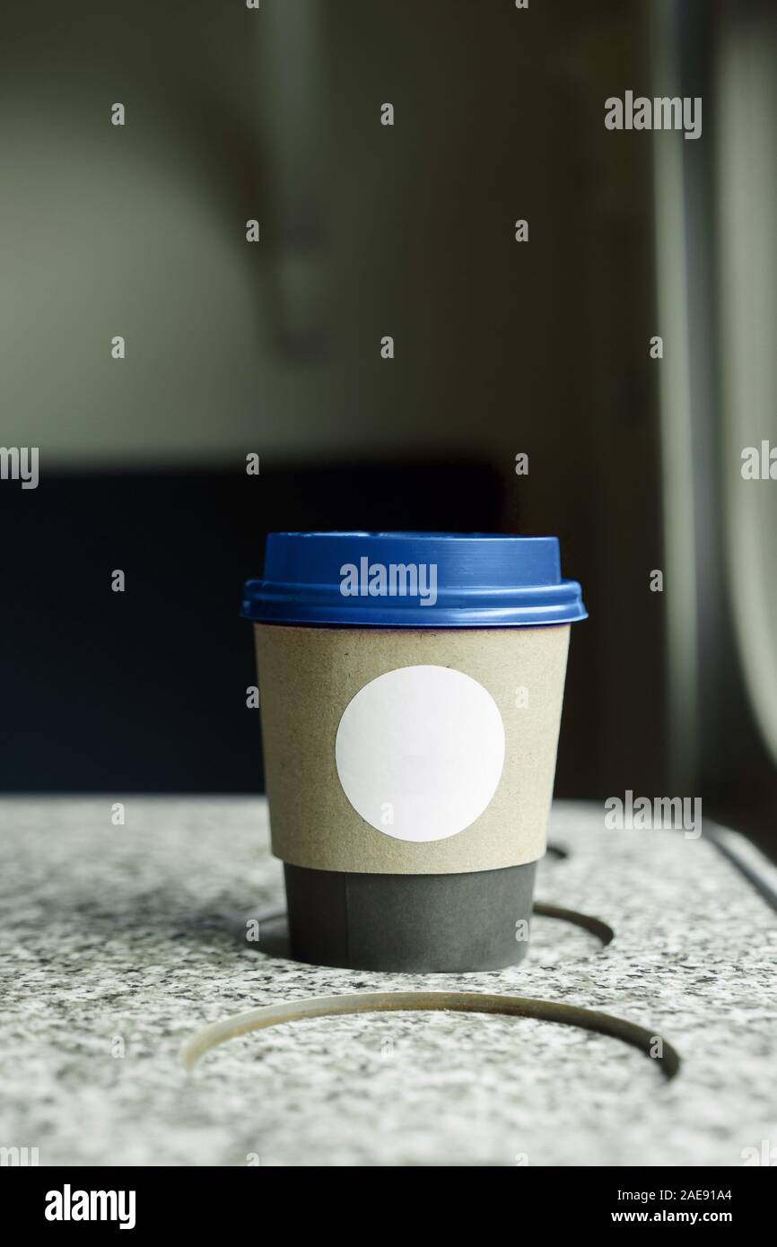 A paper coffee cup with a blue plastic lid and a white inscription circle Stock Photo