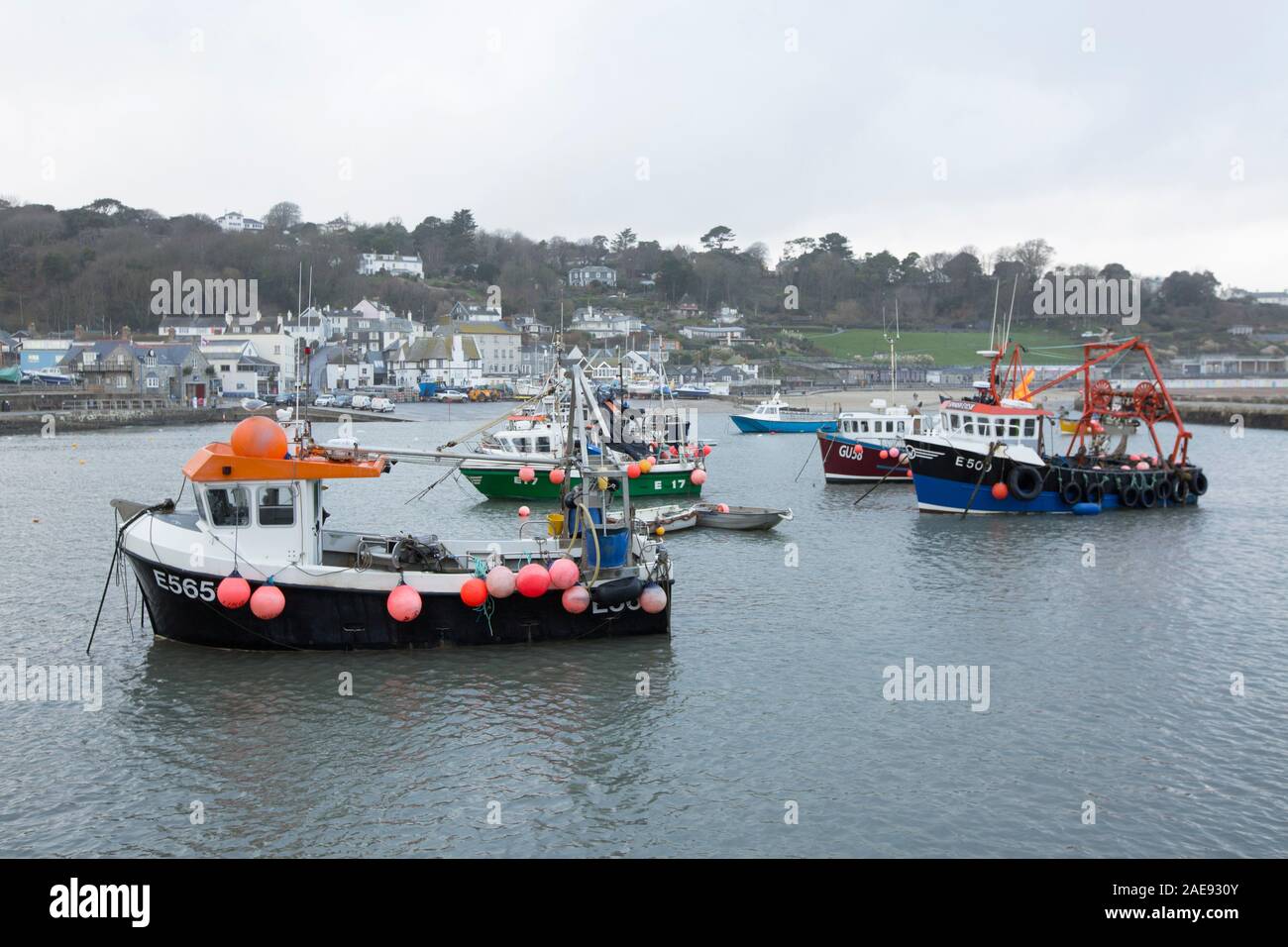 Inshore fishing boats and other vessels moored in Lyme Regis harbour in early December. Lyme Regis is situated on the heritage coast or jurassic coast Stock Photo