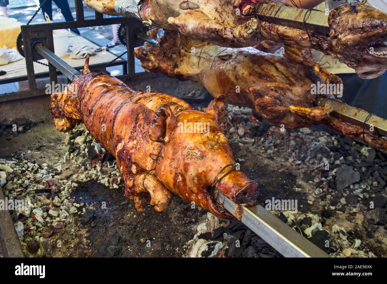 A nice roasted grilled pig on a skewer before selling to customers at the restaurant. Stock Photo