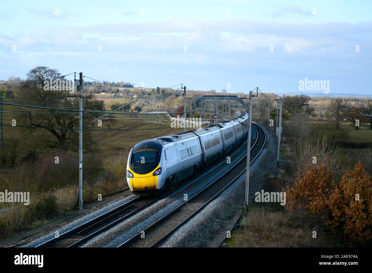 An unliveried Virgin Trains Class 390 Pendolino powers up the West Coast Main Line on the last day of the Virgin Trains Franchise, December 2019 Stock Photo