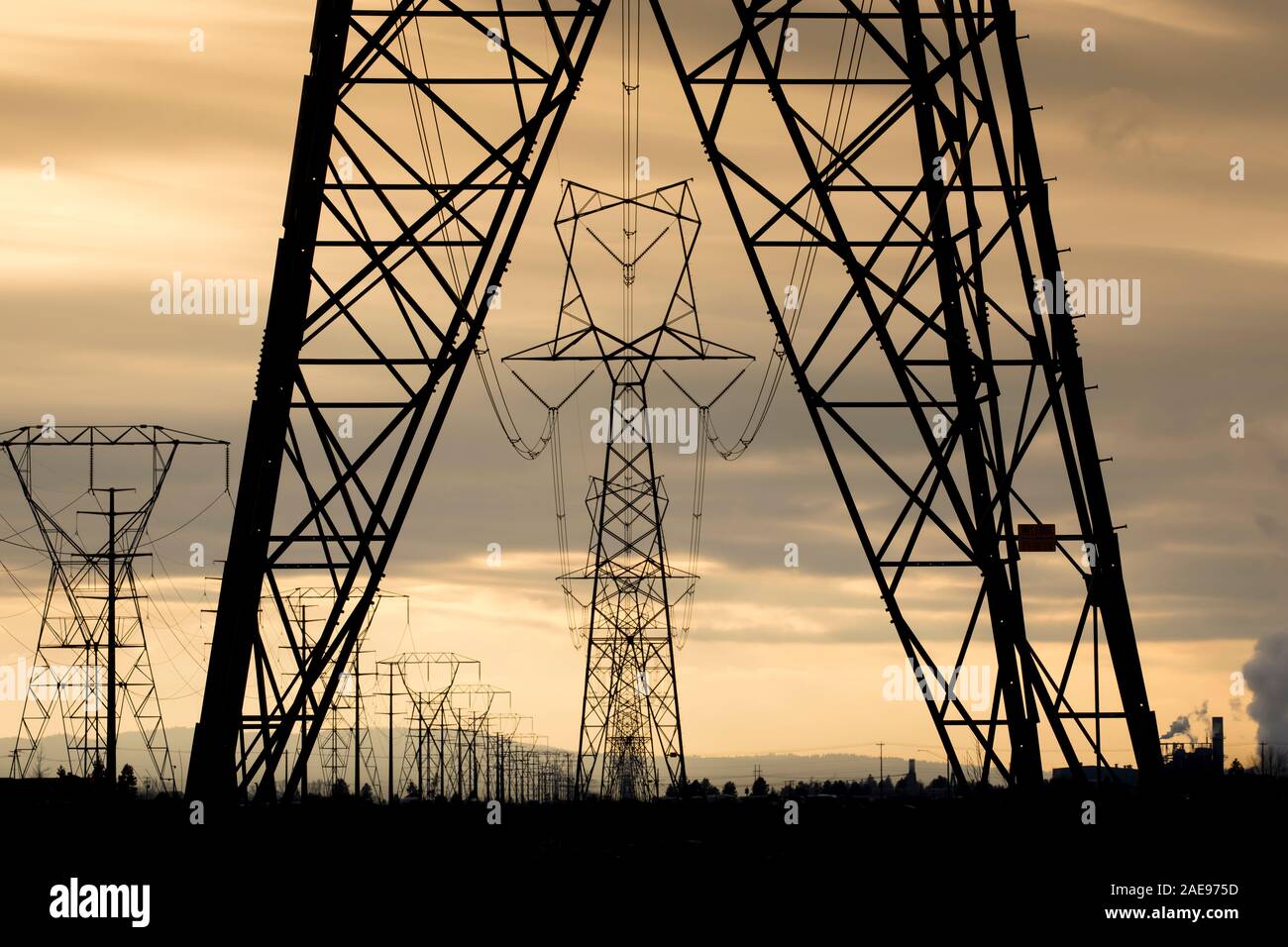 Eletrical towers and power lines close to sunset in north Idaho. Stock Photo