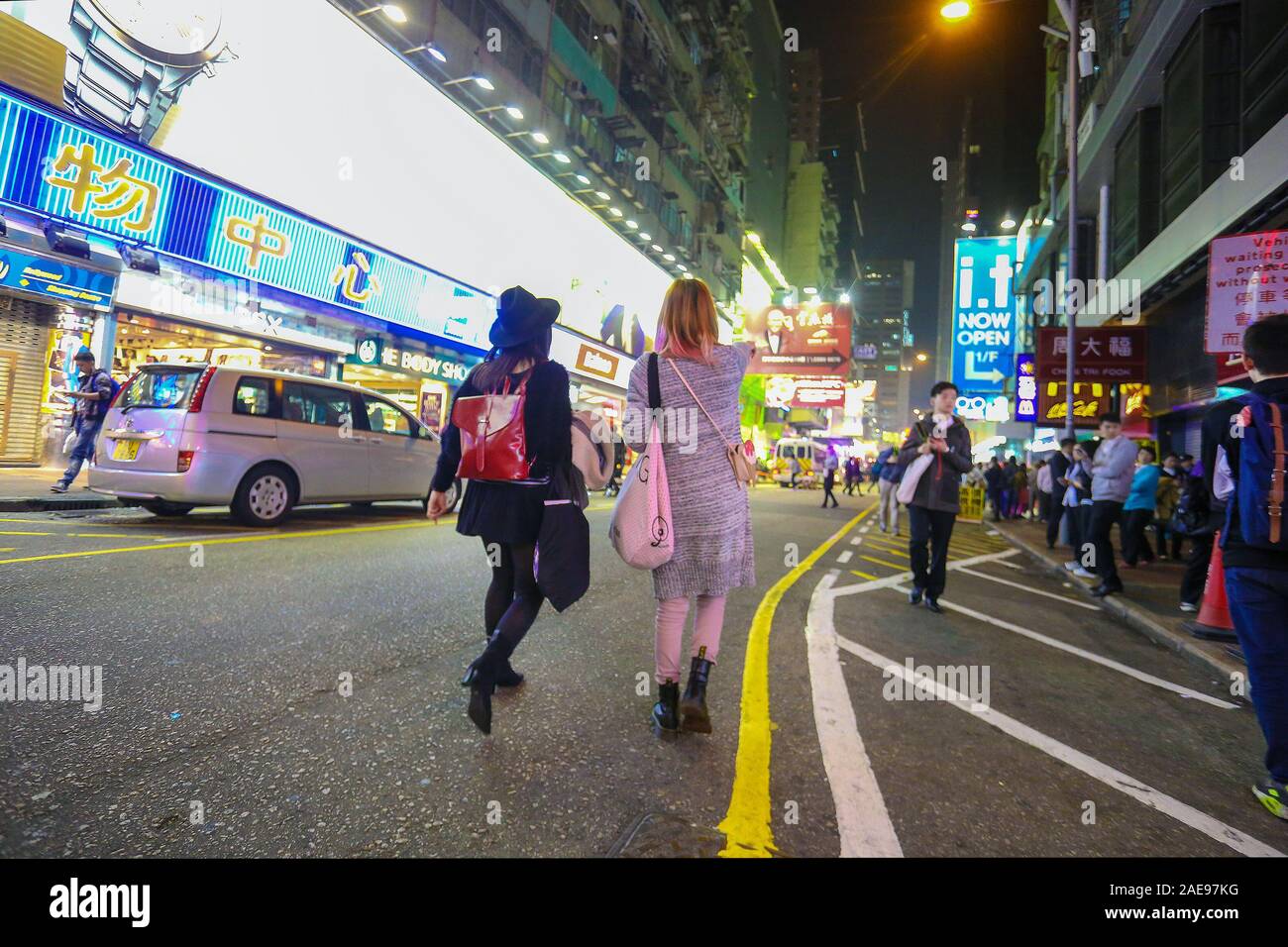 Fashionable girls on the street of Hong Kong.Night. Unrecognizable persons. Stock Photo