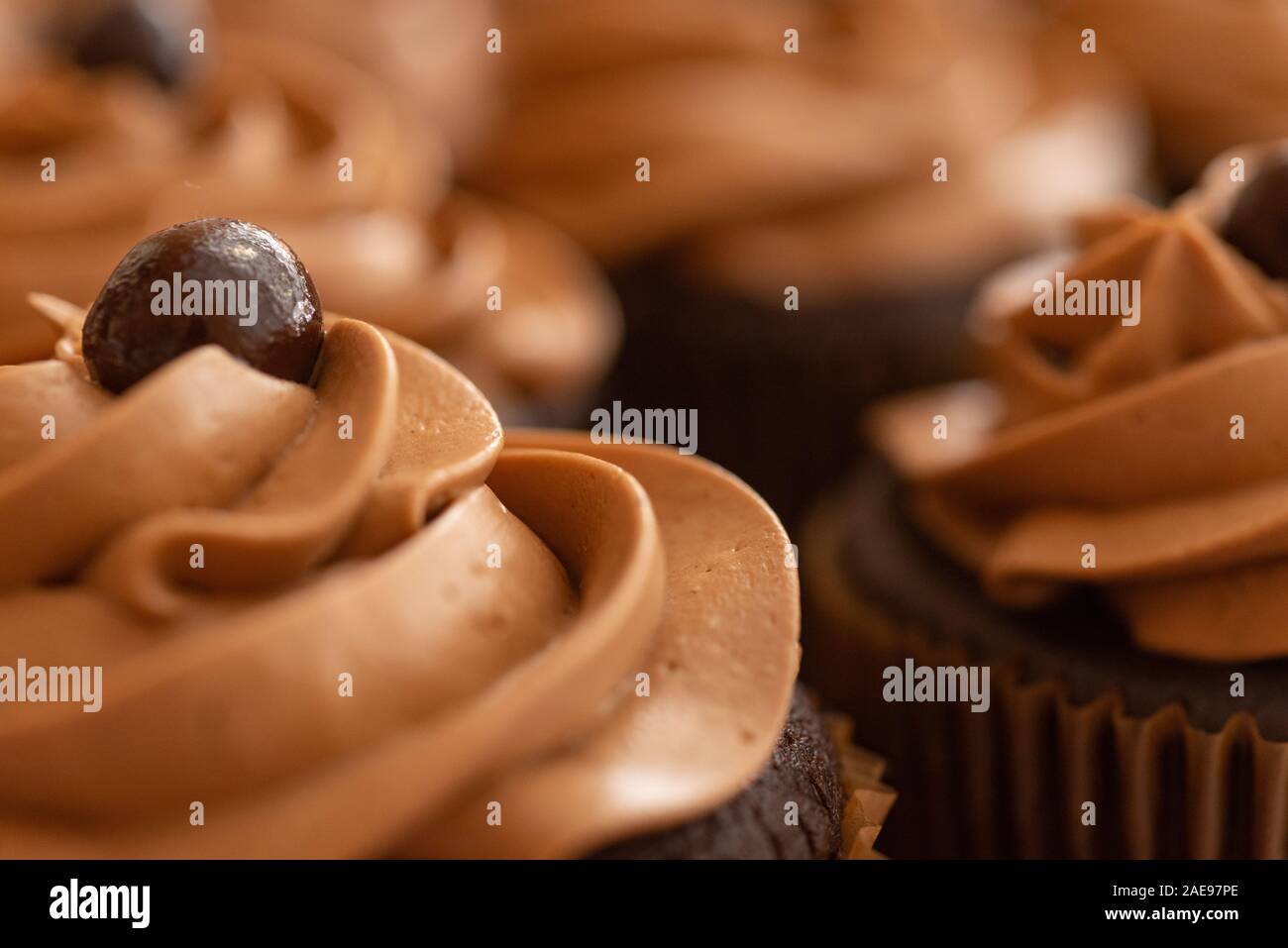 A malted milk ball sits atop a chocolate cupcake's icing Stock Photo Alamy