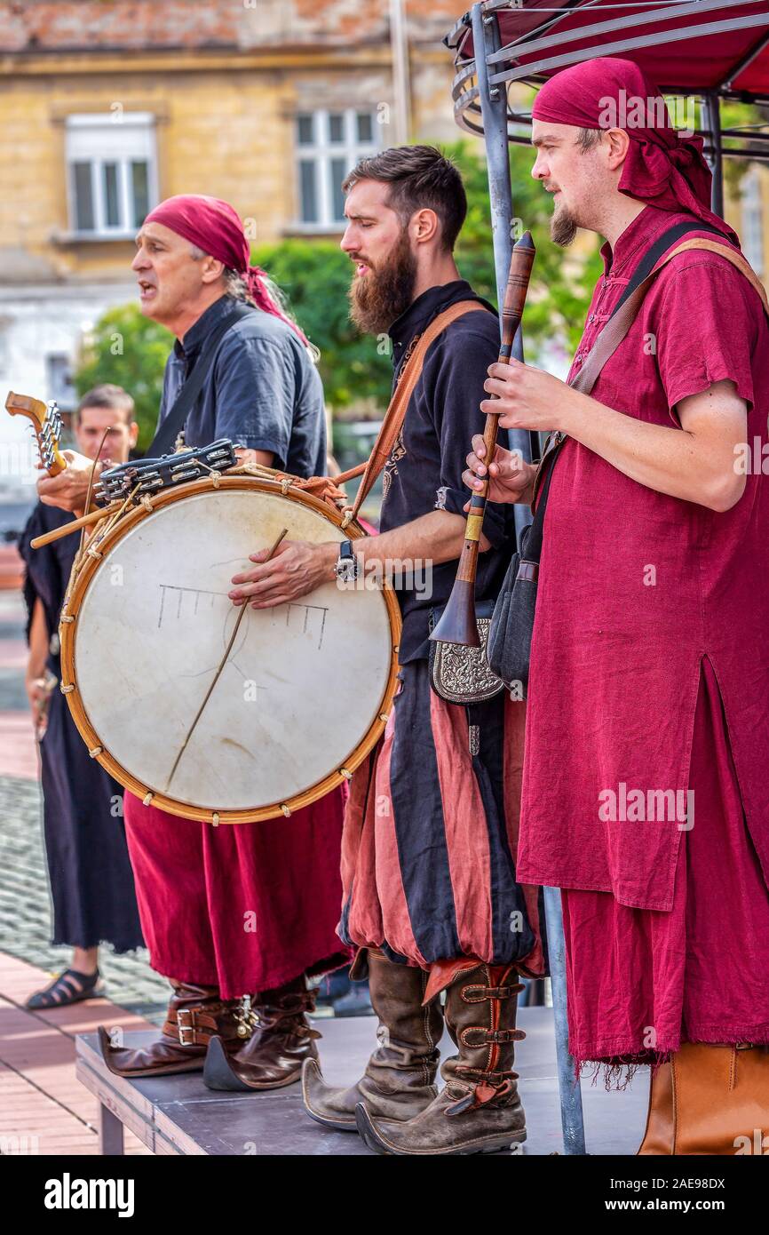 TIMISOARA, ROMANIA - SEPTEMBER 28, 2019: Men dressed in Hungarian medieval costumes and singing on the street, during the Days of hungarian culture, o Stock Photo