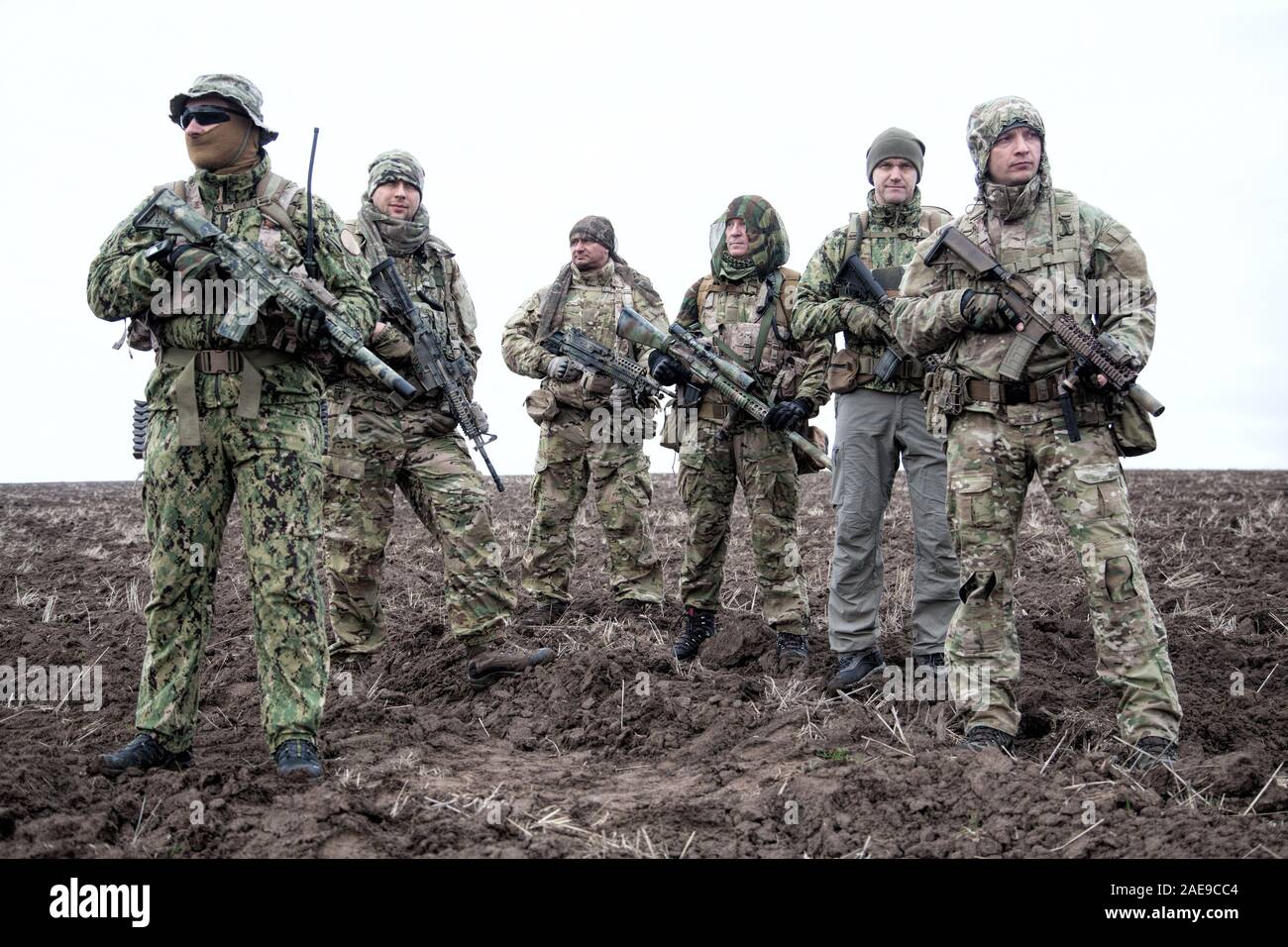 Army soldiers group on march in muddy field aaa aaaa aaaa aaa Stock Photo