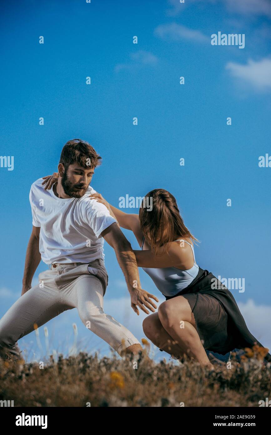 Two athletic young dancers making a performance at mountain peak Stock Photo