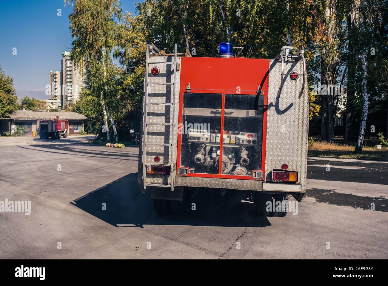 Fire engine leaving the garage of the fire station Stock Photo - Alamy