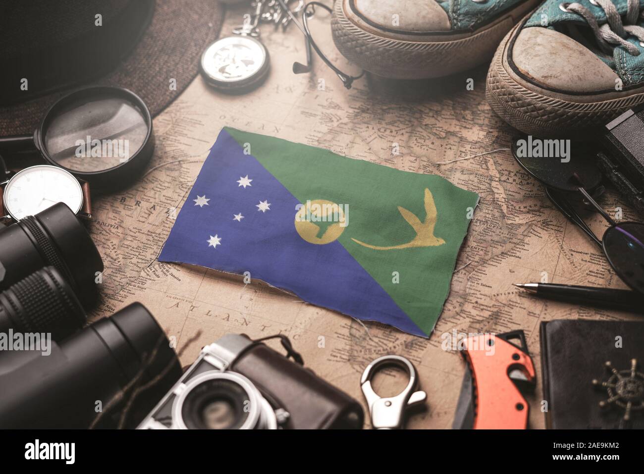 Christmas Island Flag Between Traveler's Accessories on Old Vintage Map. Tourist Destination Concept. Stock Photo