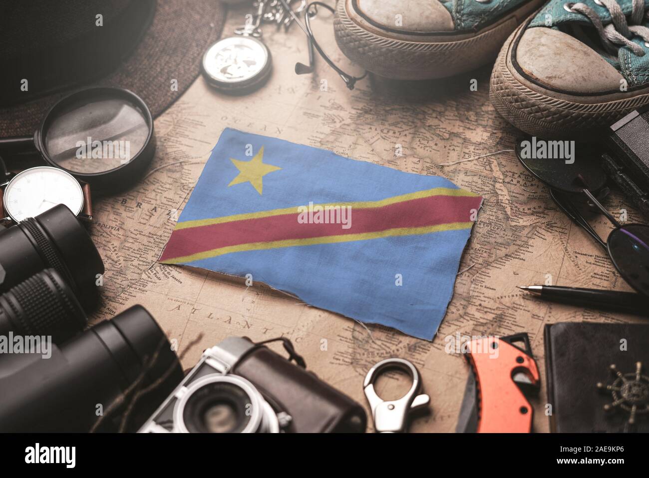 Democratic Republic of the Congo Flag Between Traveler's Accessories on Old Vintage Map. Tourist Destination Concept. Stock Photo