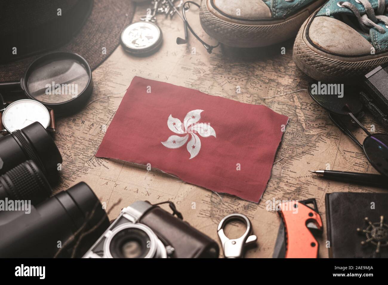 Hong Kong Flag Between Traveler's Accessories on Old Vintage Map. Tourist Destination Concept. Stock Photo