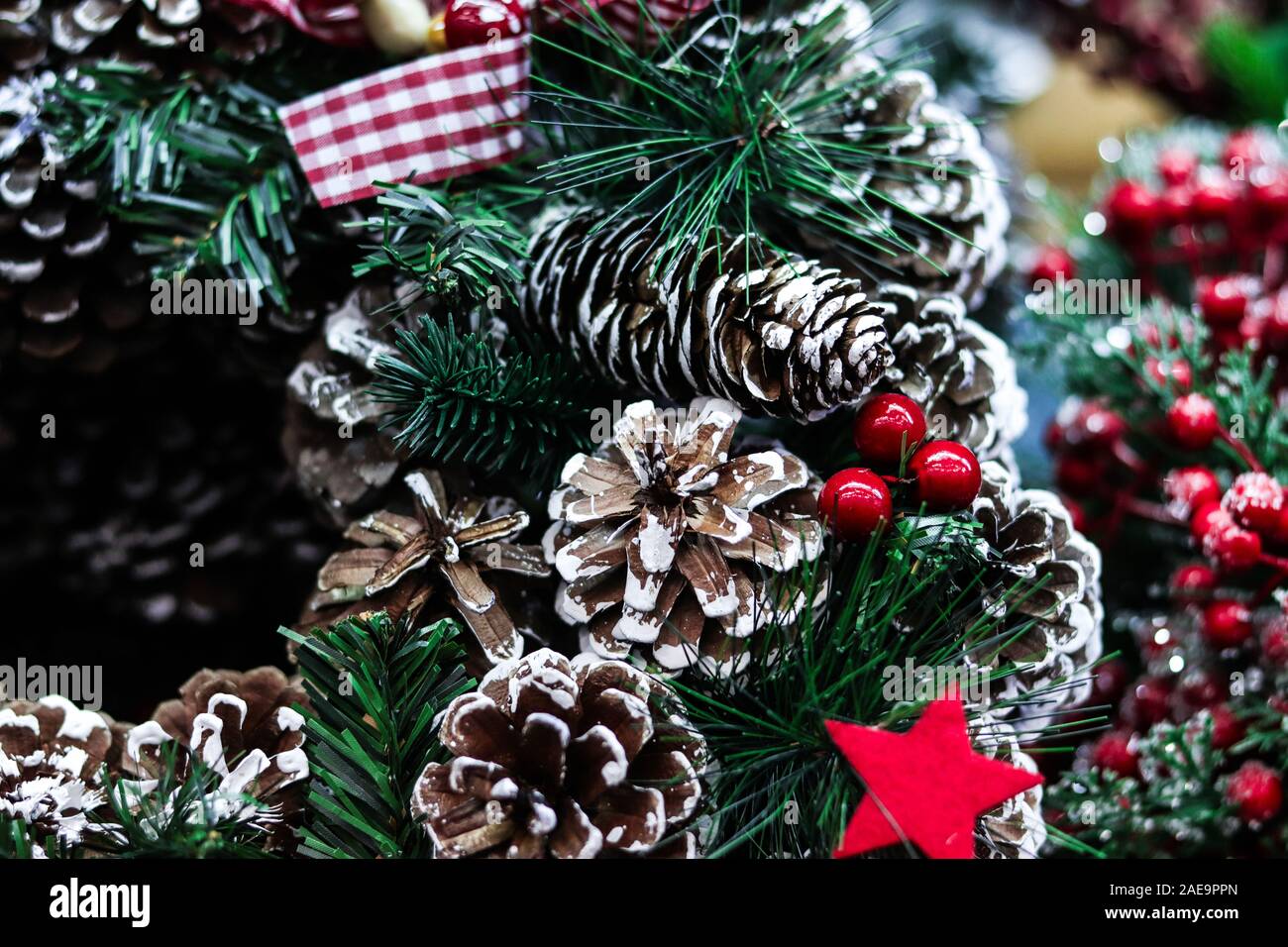 Background for Merry Christmas greetings card. Xmas wreath closeup with pine cones. Happy holidays. Stock Photo