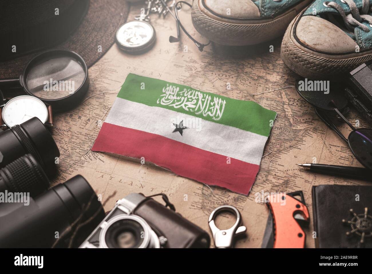 Somaliland Flag Between Traveler's Accessories on Old Vintage Map. Tourist Destination Concept. Stock Photo
