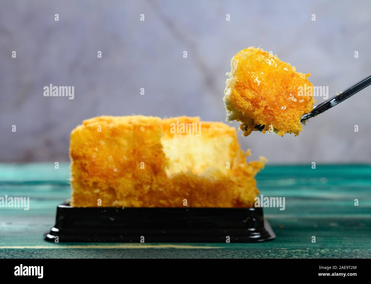 eating shredded pork cake with spoon Stock Photo Alamy