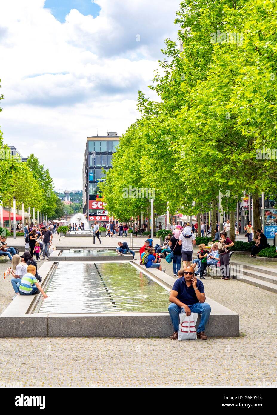 People sitting around a pond in shopping mall in central Dresden Saxony Germany. Stock Photo
