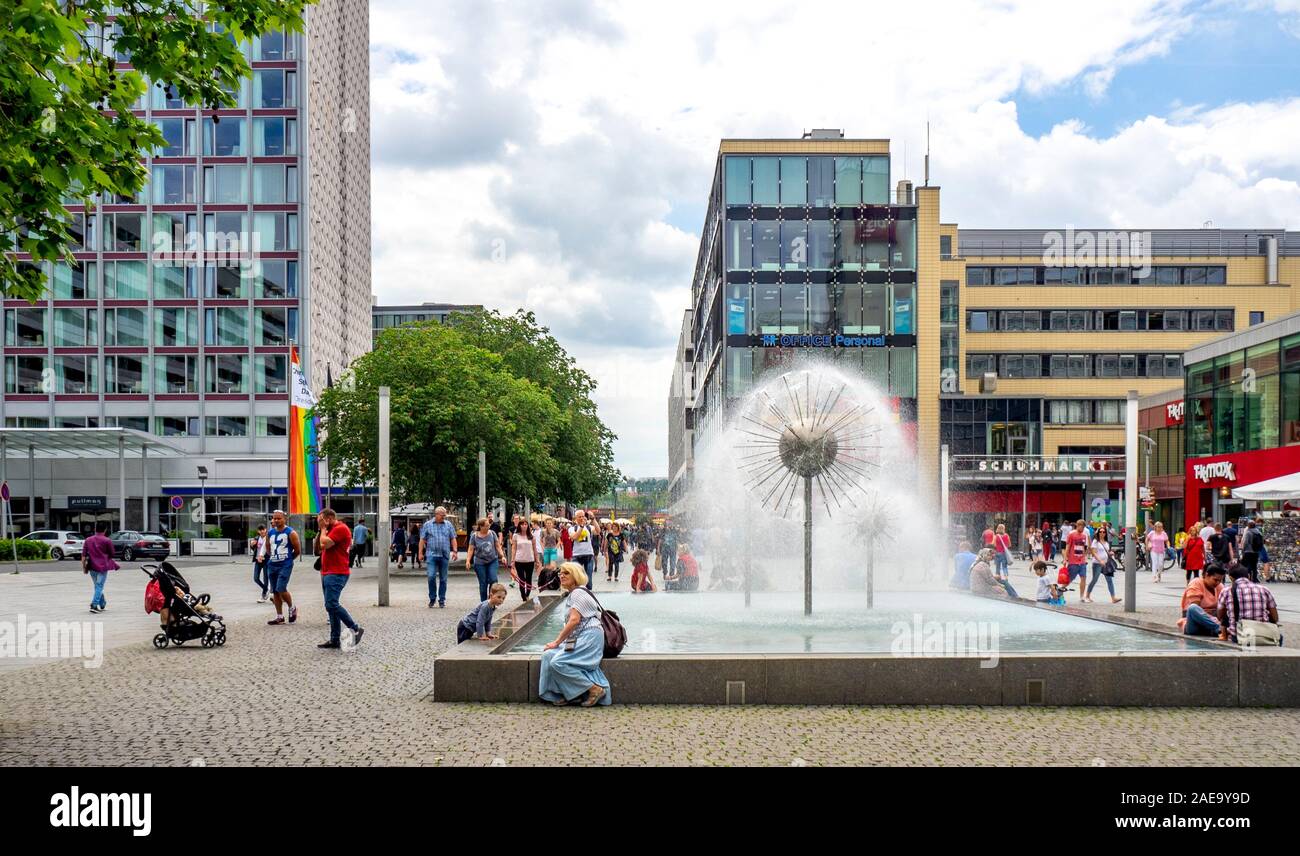 People sitting around fountain and pond in shopping mall in central Dresden Saxony Germany. Stock Photo