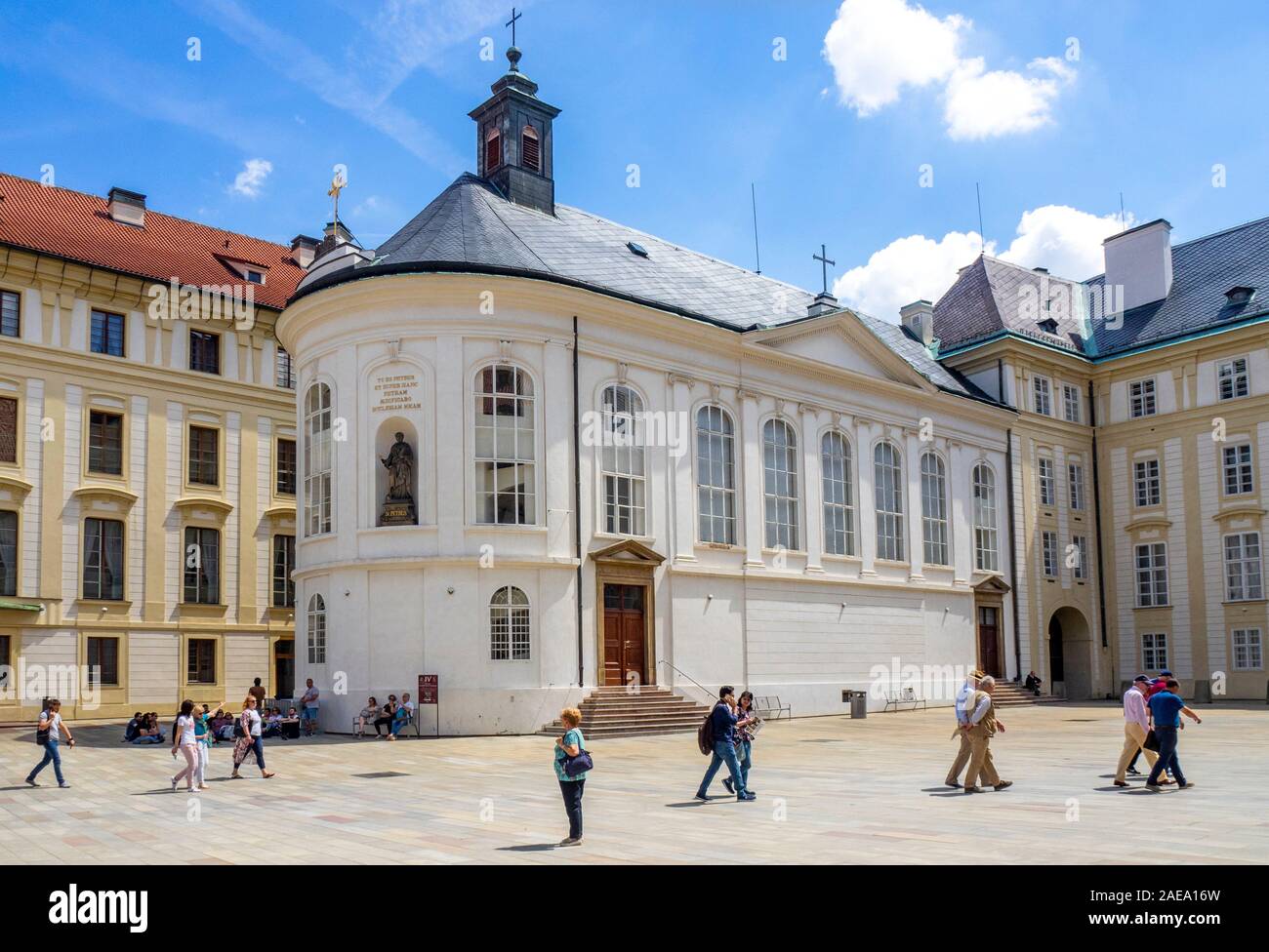 Tourists in the Second Courtyard of the Prague Castle Complex Chapel of the Holy Cross now Treasury exhibition hall Prague Czech Republic. Stock Photo