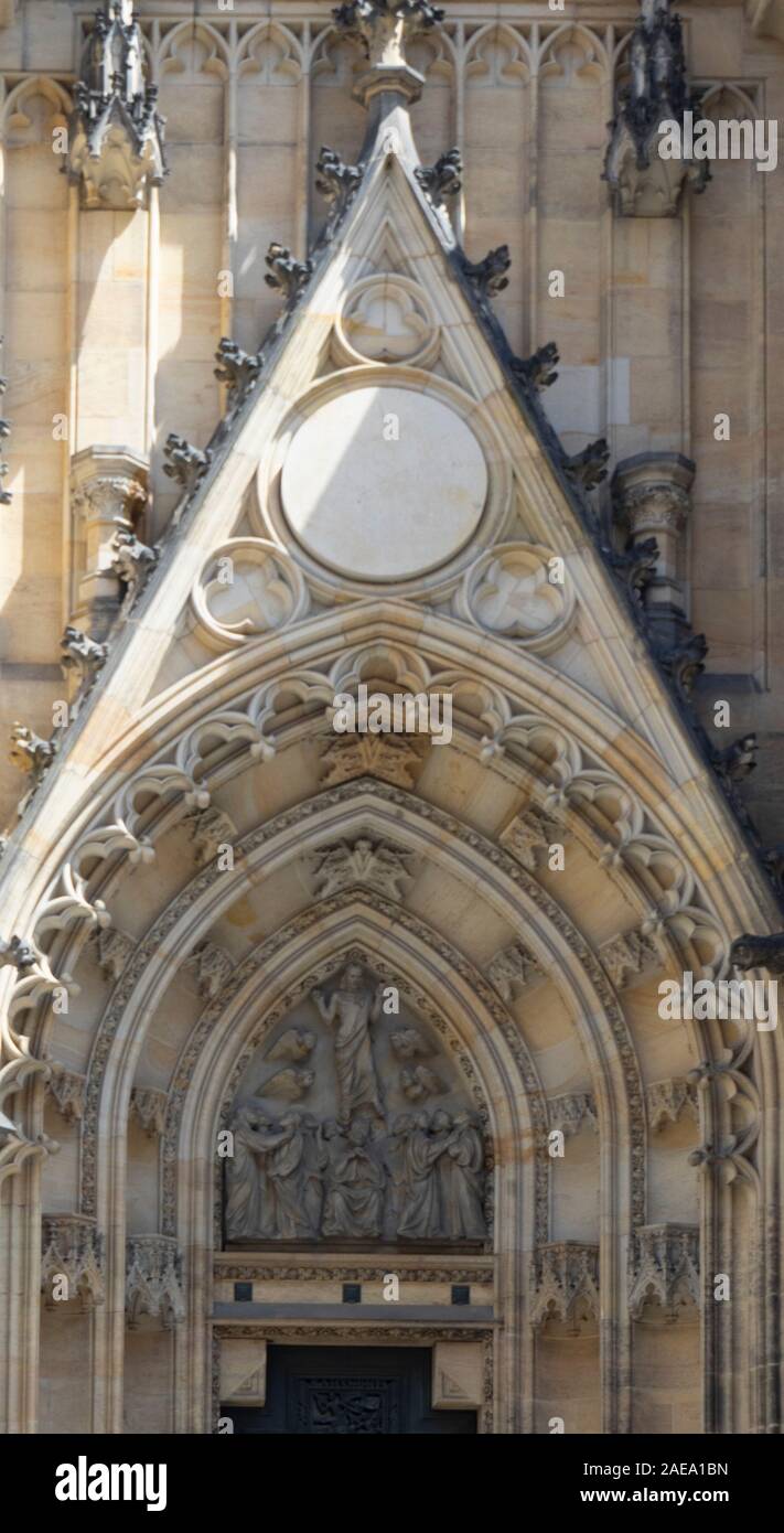 Detail of sandstone carvings and sculptures above central portal of Gothic St Vitus Cathedral Prague Castle Complex Prague Czech Republic. Stock Photo