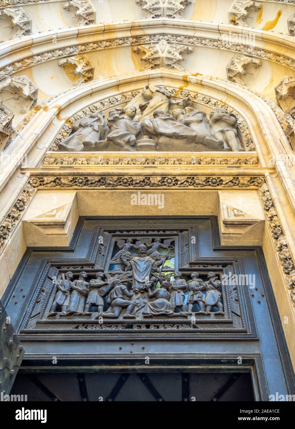 Detail of bronze sculpture and sandstone carvings above side  portal of Gothic St Vitus Cathedral Prague Castle Complex Prague Czech Republic. Stock Photo