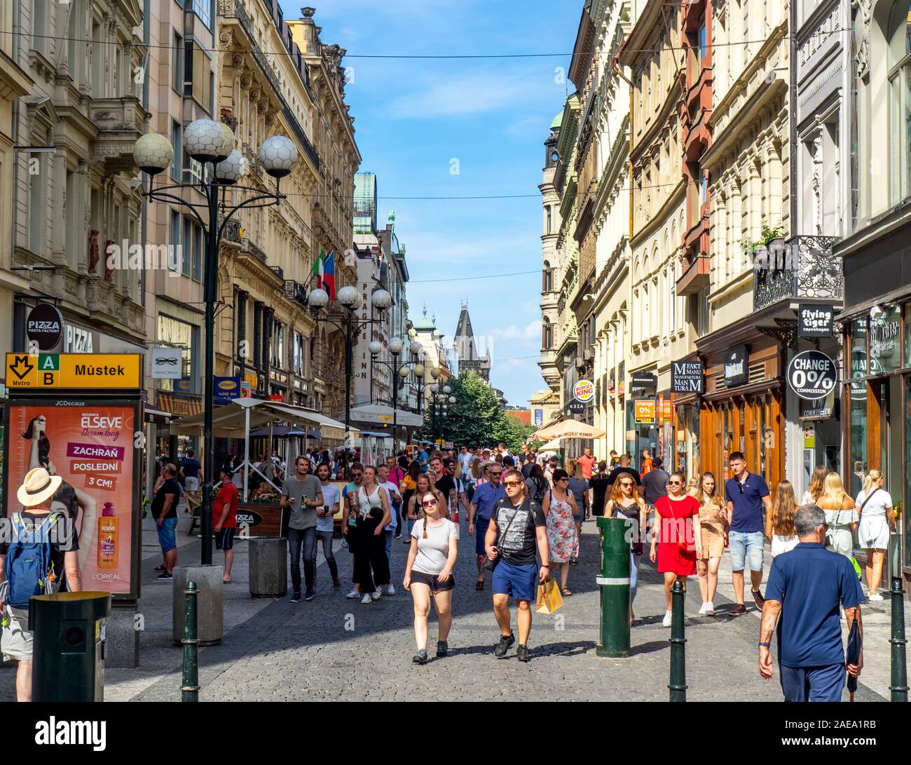 Crowds of tourists walking along cobblestone 28. Října street lined with touristic shops and cafes Old Town Prague Czech Republic. Stock Photo