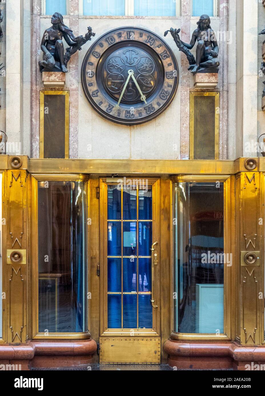 Decorative and ornate Art Deco style bronze statuettes and 24 hour clock  in foyer of Adria Passage Adria Palace New Town Prague Czech Republic. Stock Photo