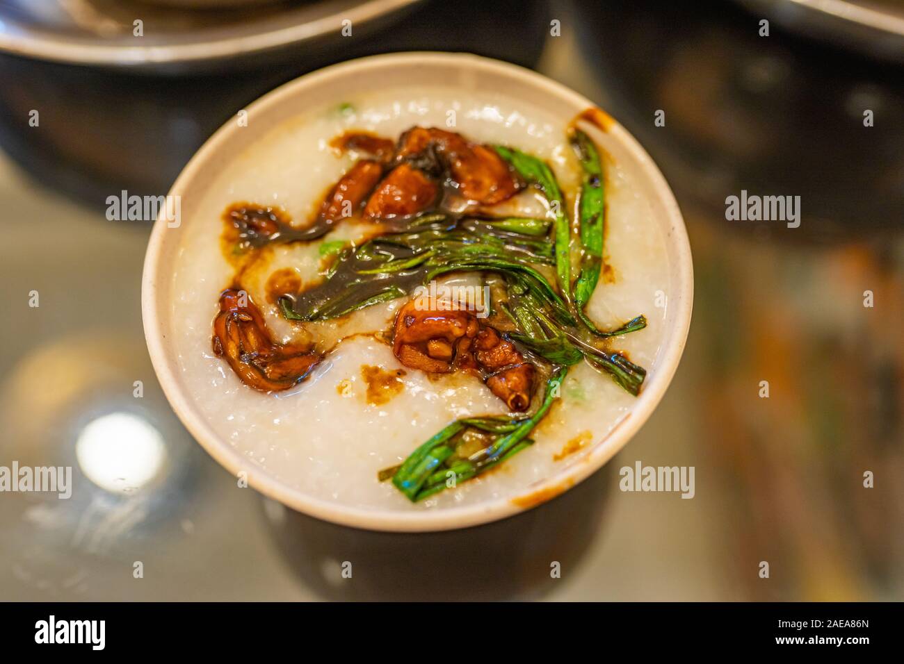 Bowl of delicious Singapore frog porridge in restaurant Stock Photo
