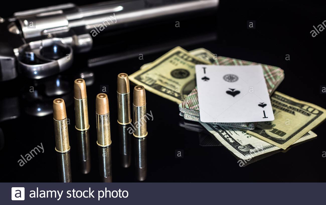 Dangerous gambling for money. A pistol with cartridges, money ...