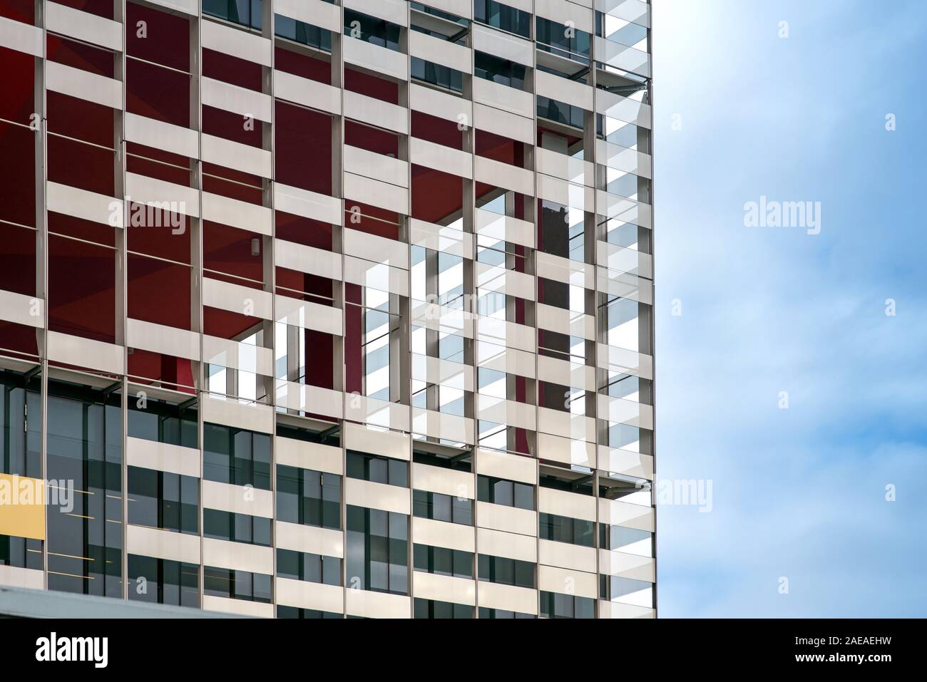 Exterior facade of a modern apartment or office block in close up detail against a hazy blue sky Stock Photo