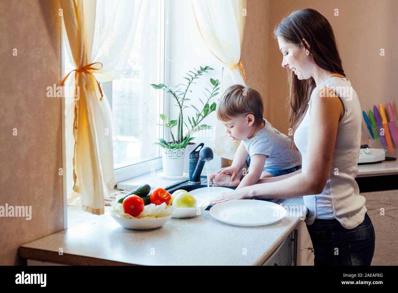 kitchen mom son wash fruits and vegetables Stock Photo - Alamy.