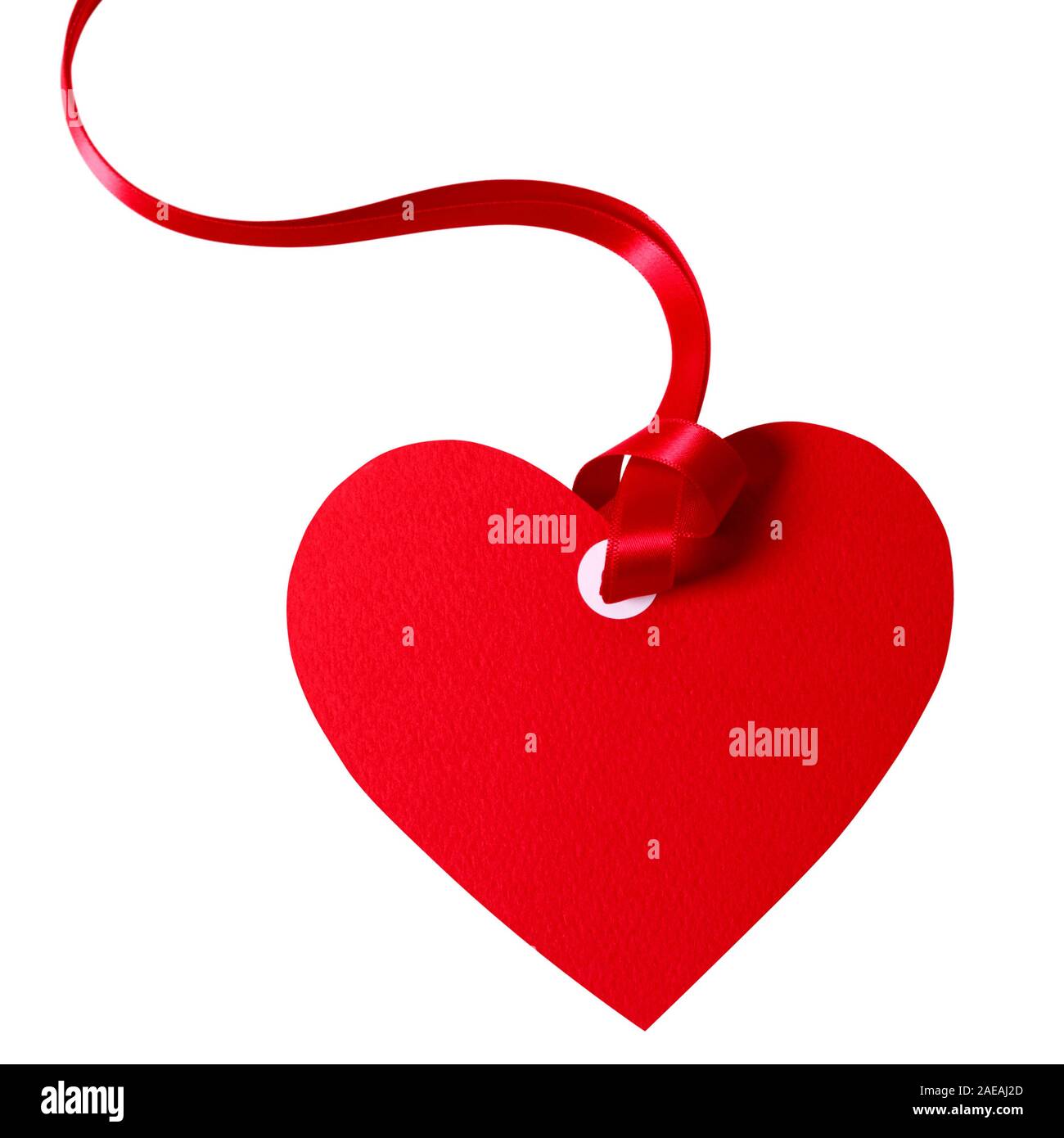 Valentine card or heart shaped gift tag with red ribbon isolated on a white background. Stock Photo