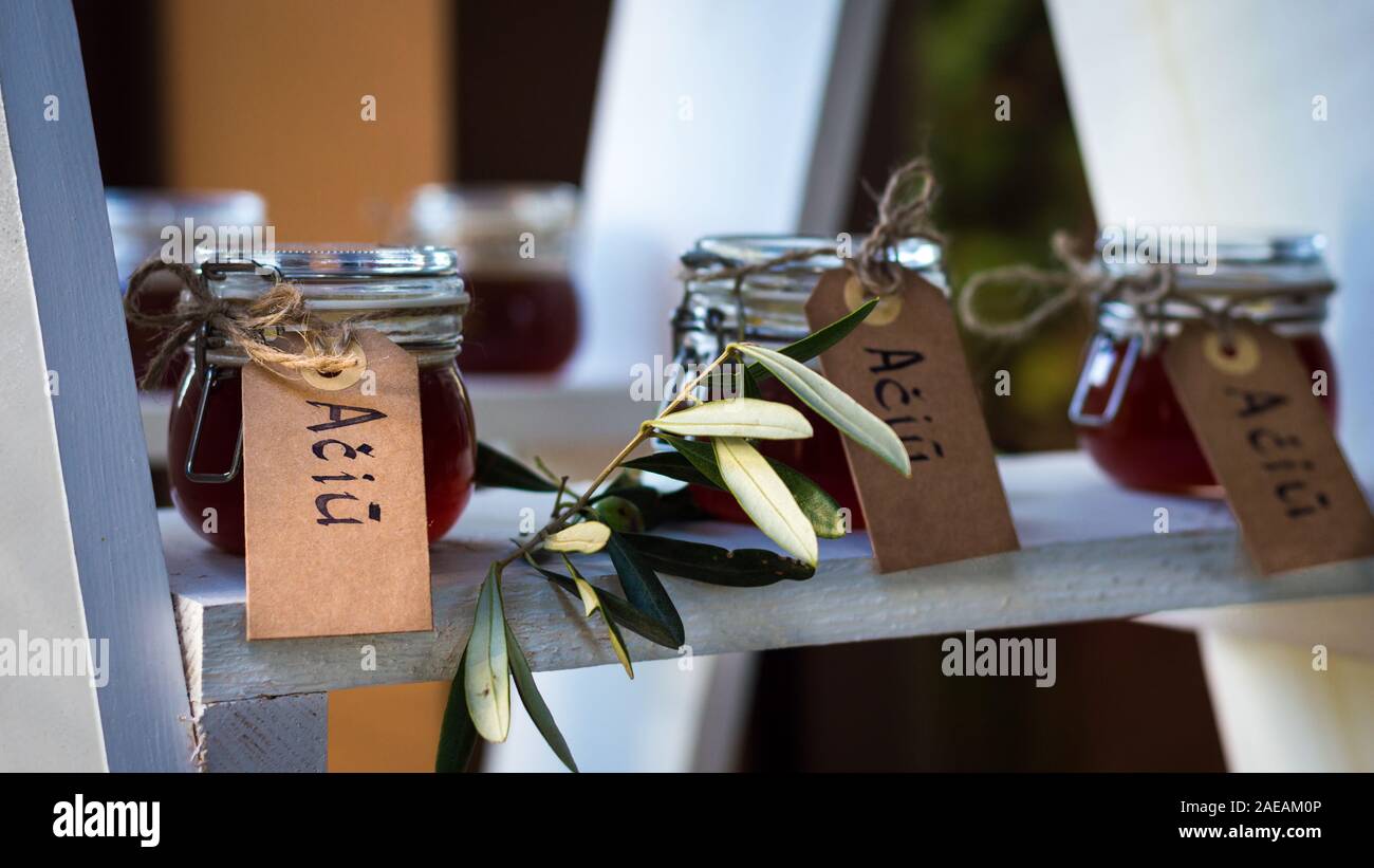 Small Glass Jars Filled With Honey Decorated With Eucalyptus And