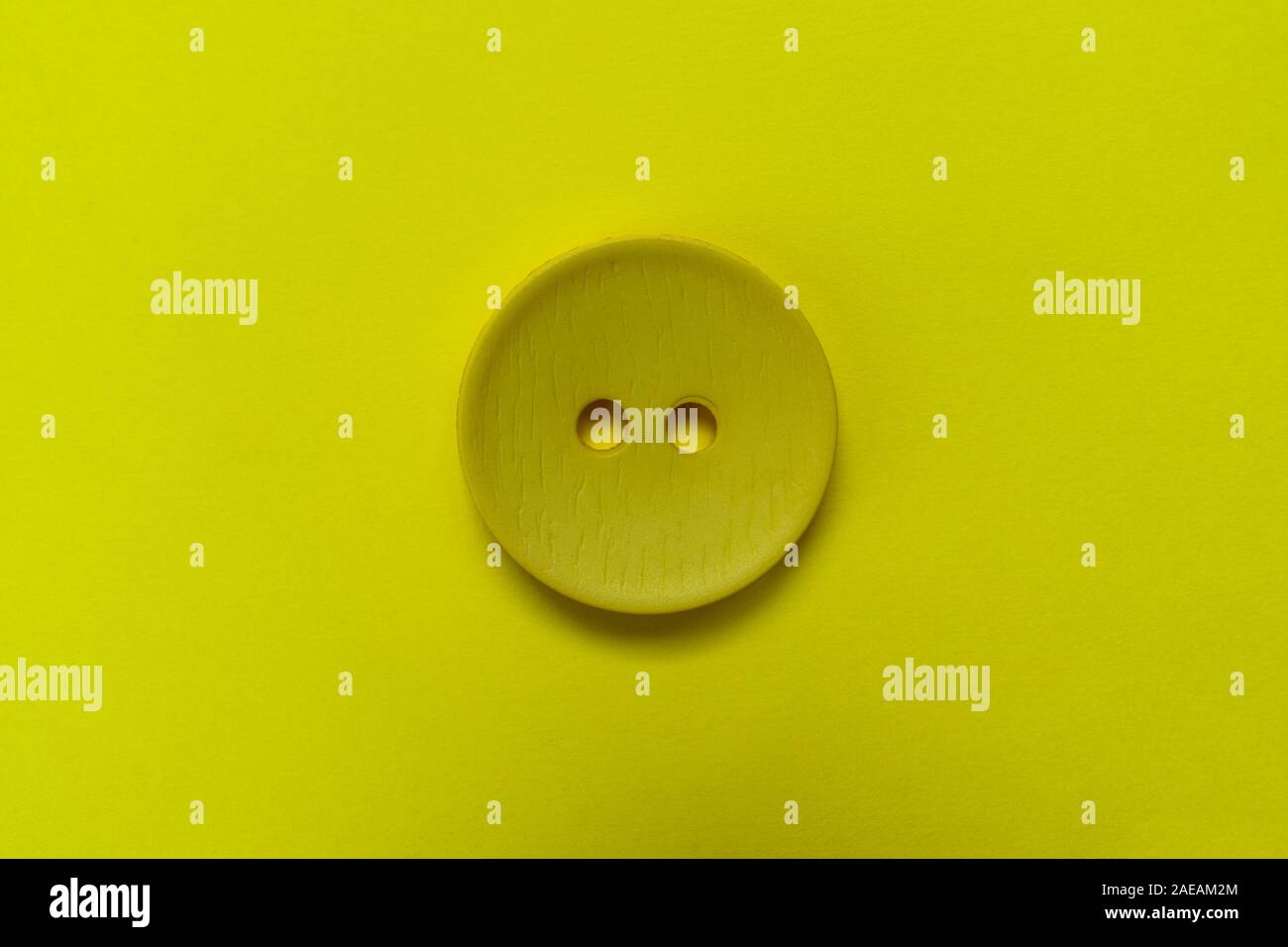 Big black button isolated on a black background. Stock Photo