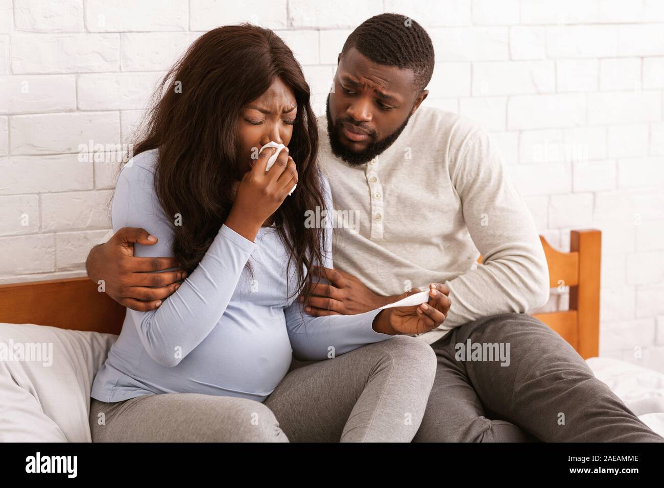 Loving husband taking care about his sick pregnant woman Stock Photo