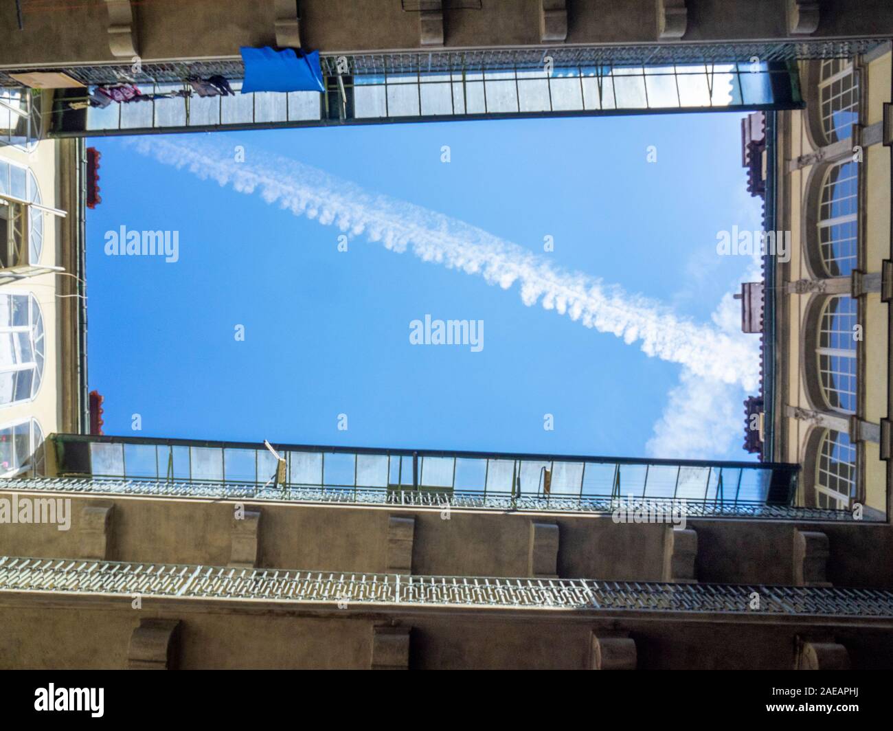 Blue sky and contrail seen from a courtyard of a building in Old Town Prague Czech Republic. Stock Photo