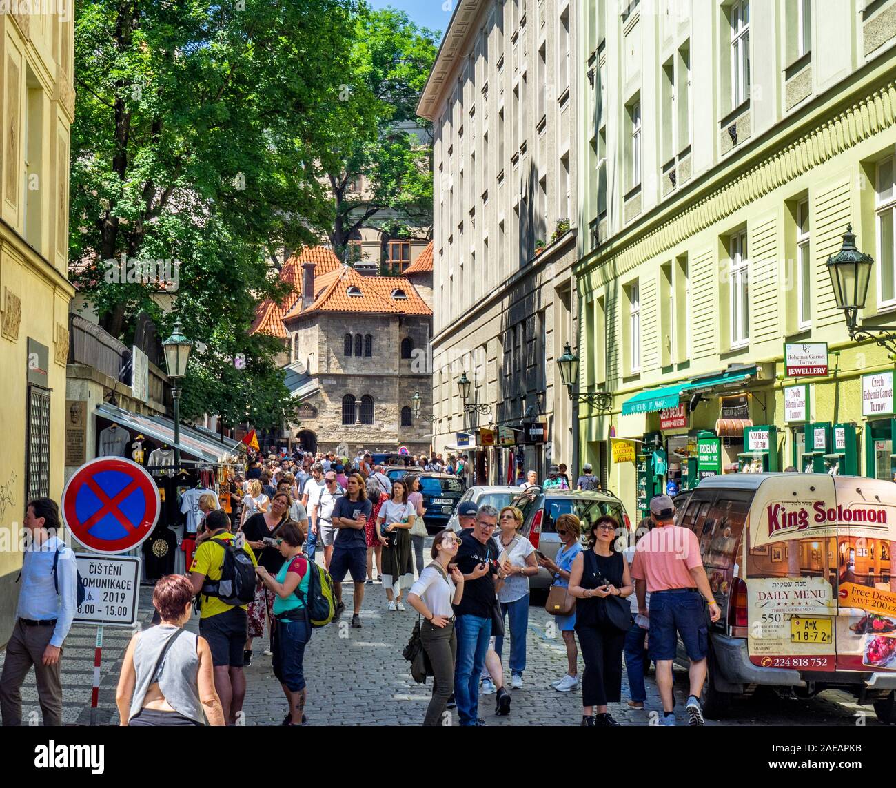 Tourists on U Starého Hřbitova street with Klausen synagogue on left and Ceremonial Hall and Jewish Cemetery ahead in Jewish Quarter Old Town Prague. Stock Photo