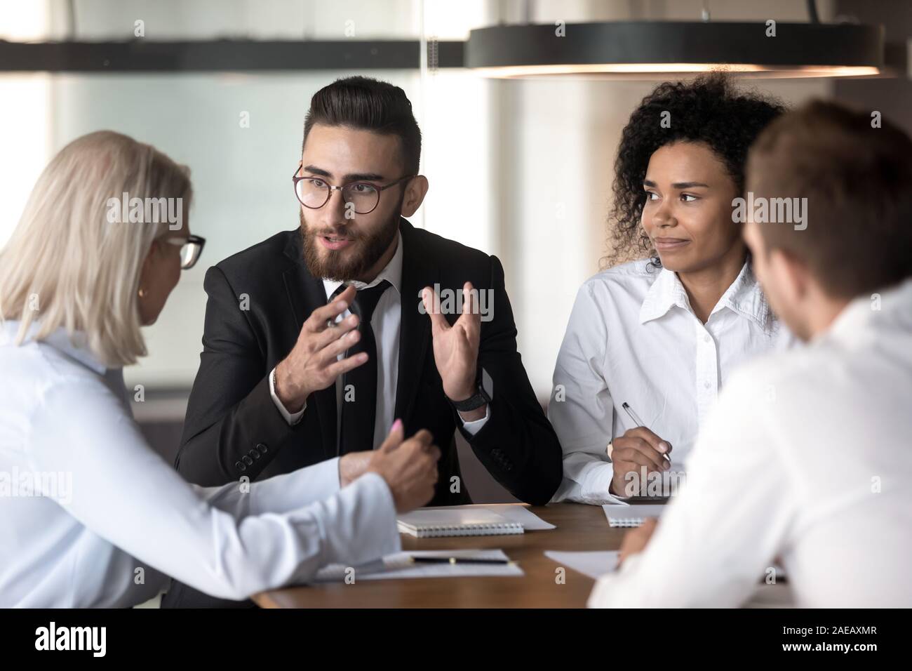Diverse businesspeople discuss business ideas at team meeting Stock ...