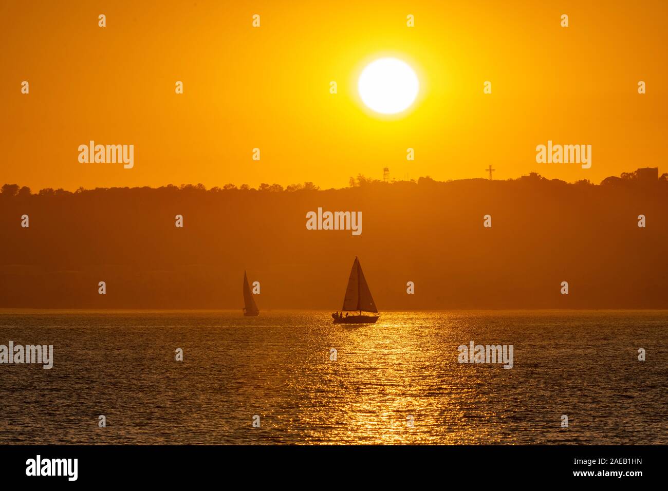 Sailing with the wind at the sunset time Stock Photo