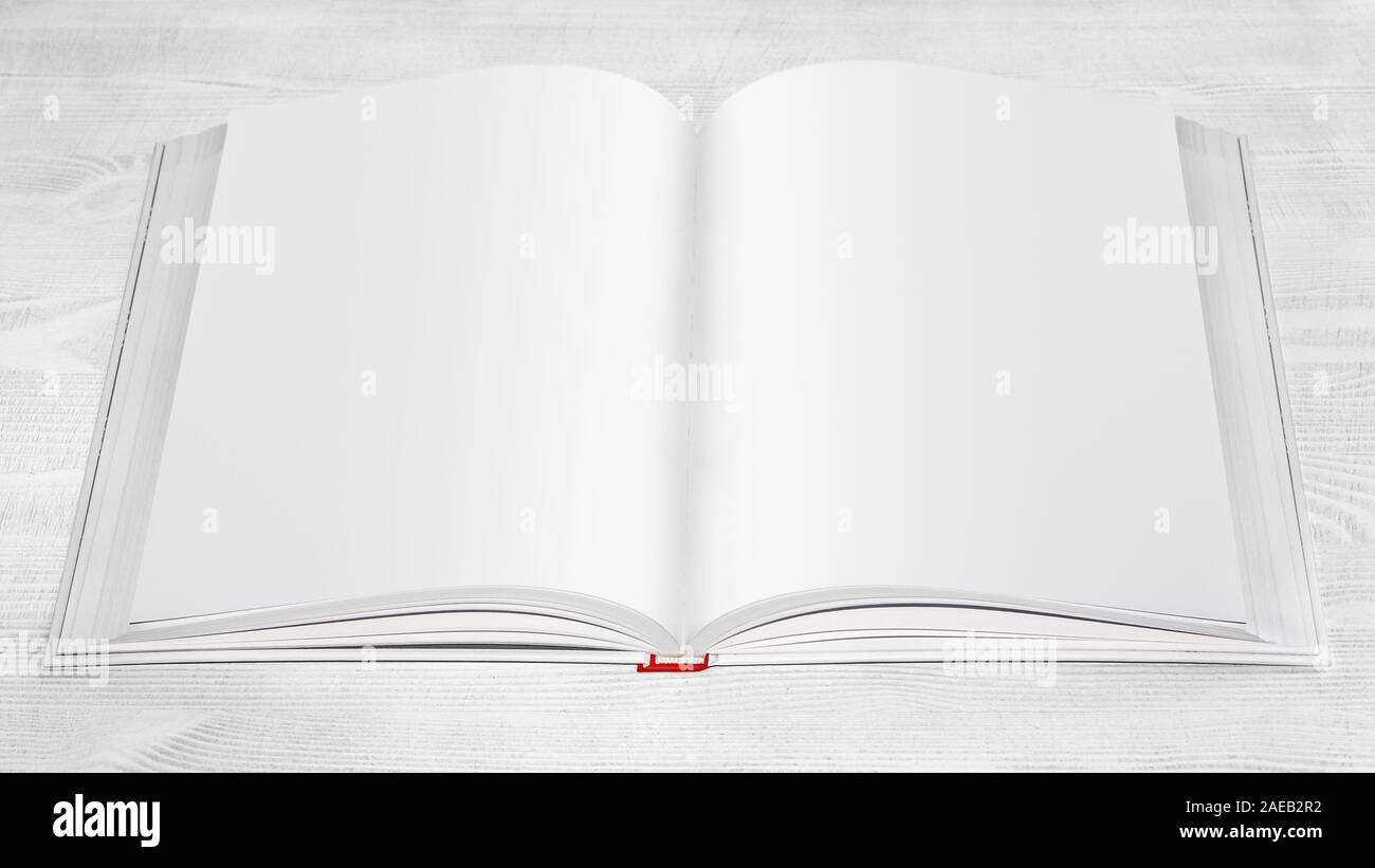 Open book on a white wooden table. Stock Photo