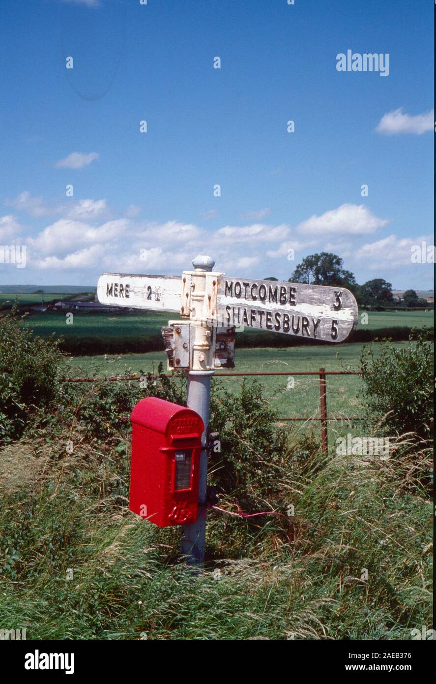 Old road sign and post box near Shaftesbury, Dorset, South West England, Uk, in 1988 Stock Photo